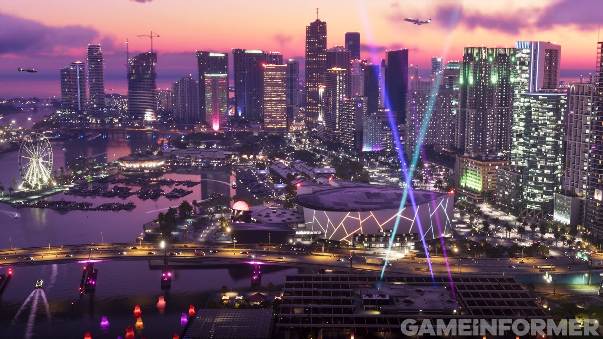 Panorama urbano iluminado junto à água, com uma roda-gigante, publicado pela Game Informer.