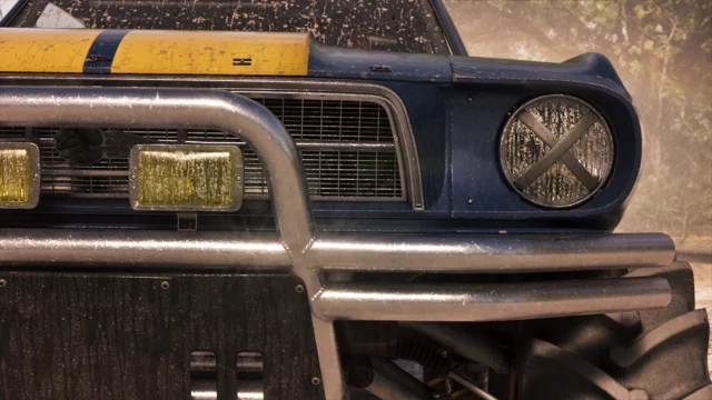 Plano fechado da frente de um veículo Vapid Dominator Buggy (1967) que passa por uma trilha off-road.